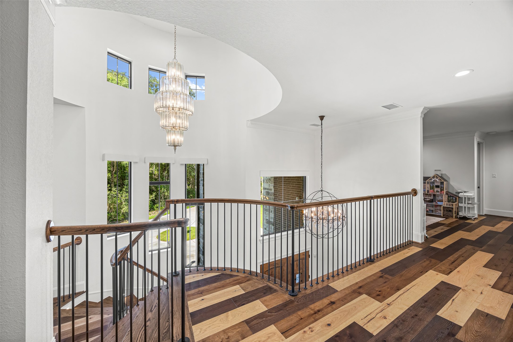 19314 Chateau Ridge Court Tomball, TX 77377 - Photo 27 of 50 Second-floor landing highlighted by elegant, high-end chandeliers that enhance the home’s upscale lighting design.