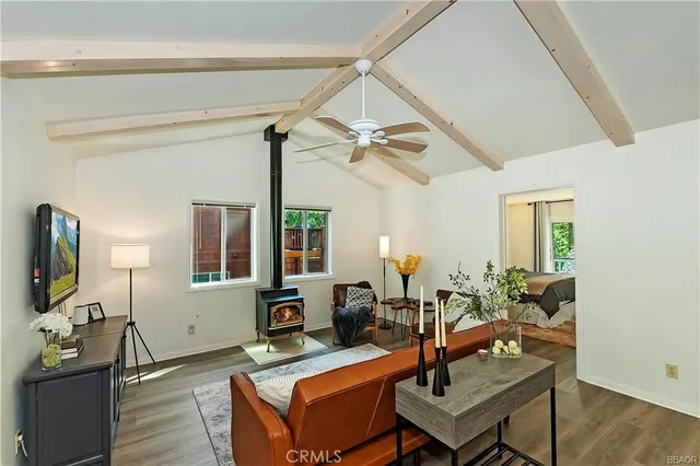 a living room with furniture a flat screen tv and a window