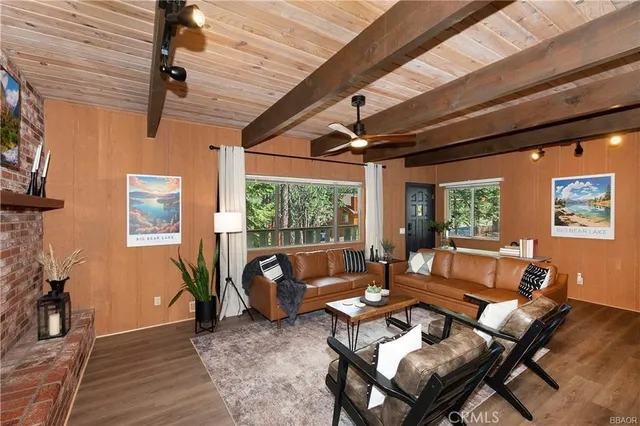 a living room with furniture a flat screen tv and a table