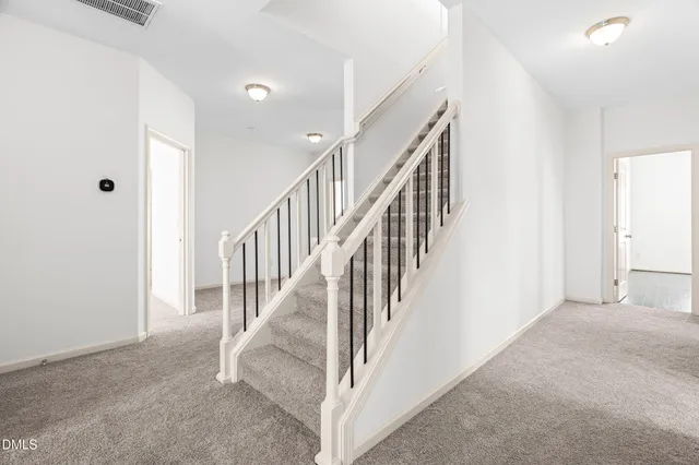 an empty room with chandelier fan