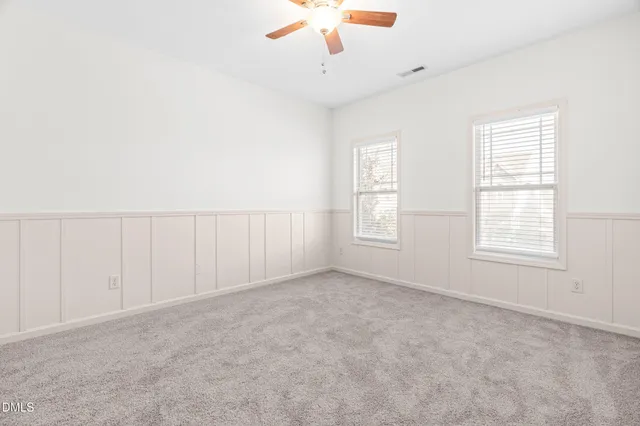 a utility room with granite countertop cabinets washer and dryer