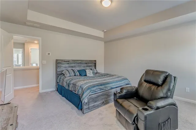 a bedroom with a bed and chair