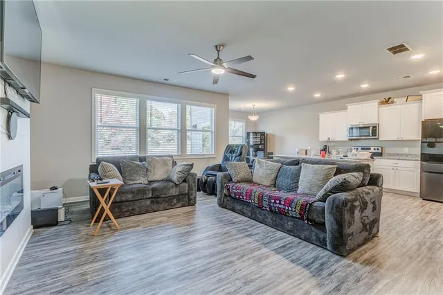 a living room with furniture and a large window