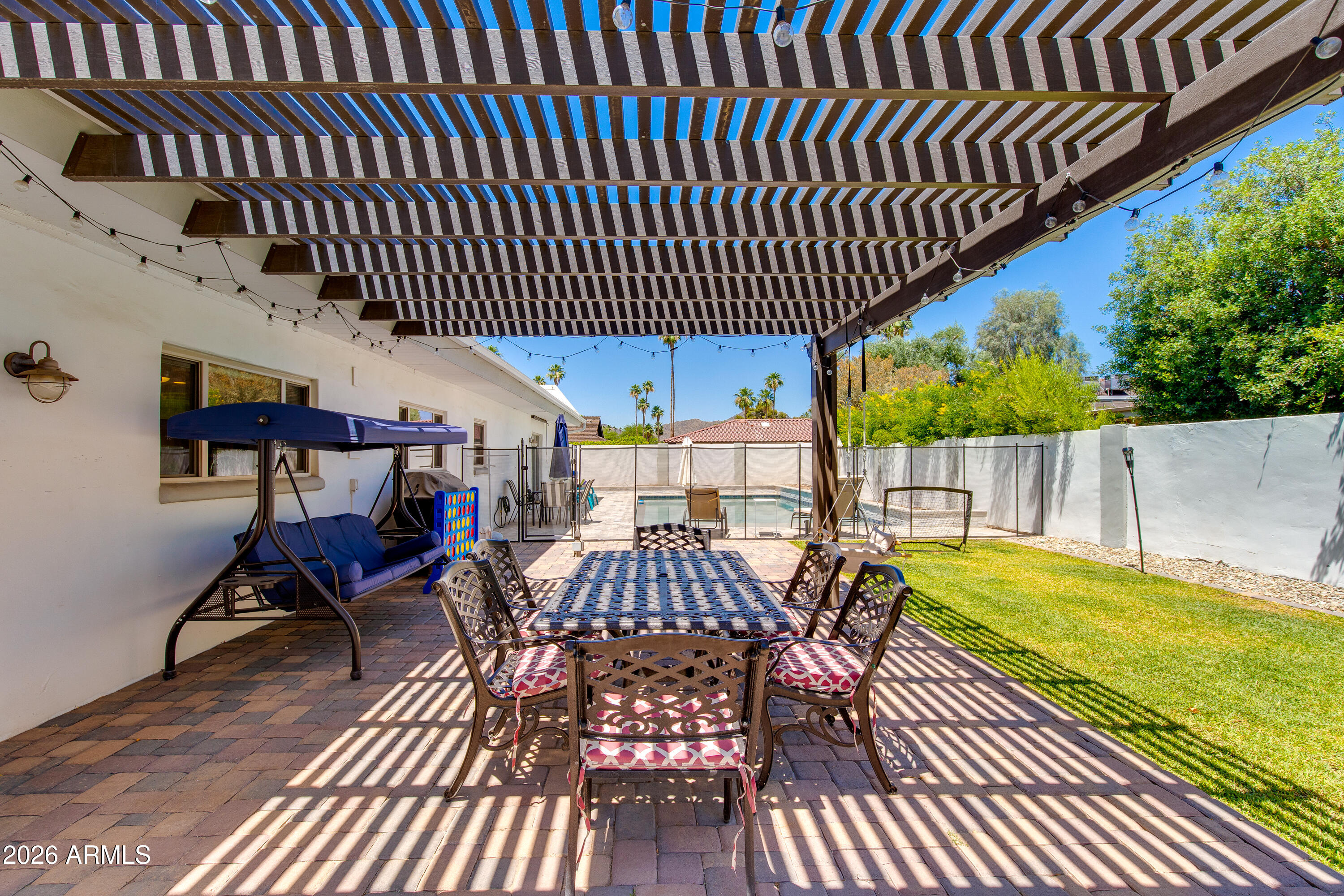 8219 North 3rd Avenue Phoenix, AZ 85021 - Photo 42 of 52 a view of a patio with table and chairs with wooden floor and fence