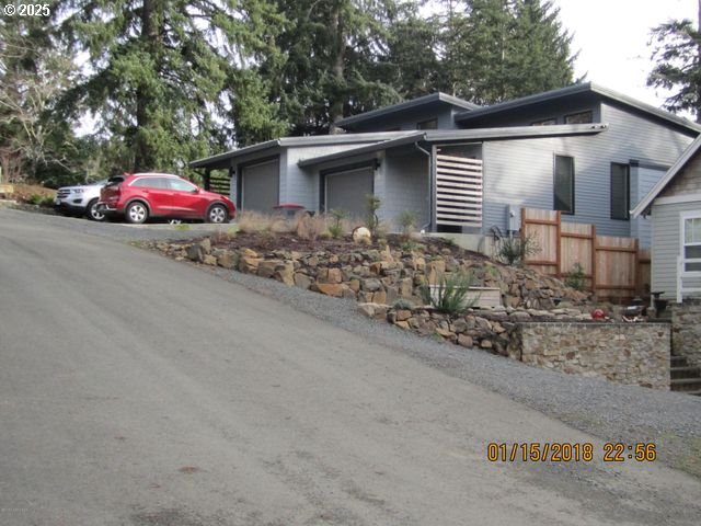 Birch Street Cannon Beach, OR 97110 - Photo 14 of 17 a front view of a house with yard