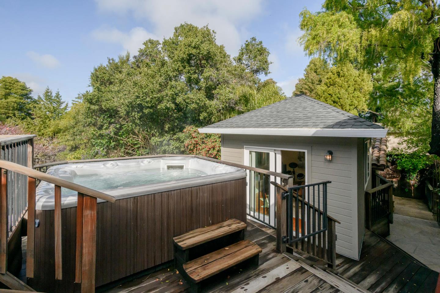 2950 Summit Drive Hillsborough, CA 94010 - Photo 15 of 27 a roof deck with table and chairs under an umbrella