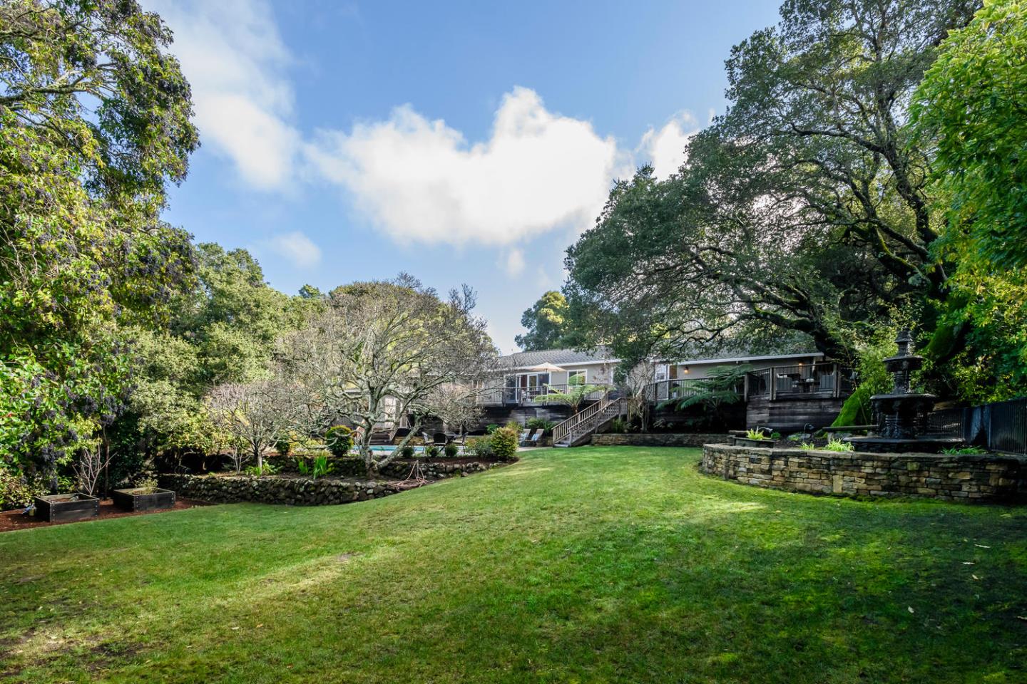 2950 Summit Drive Hillsborough, CA 94010 - Photo 18 of 27 a view of a yard with plants and a fountain