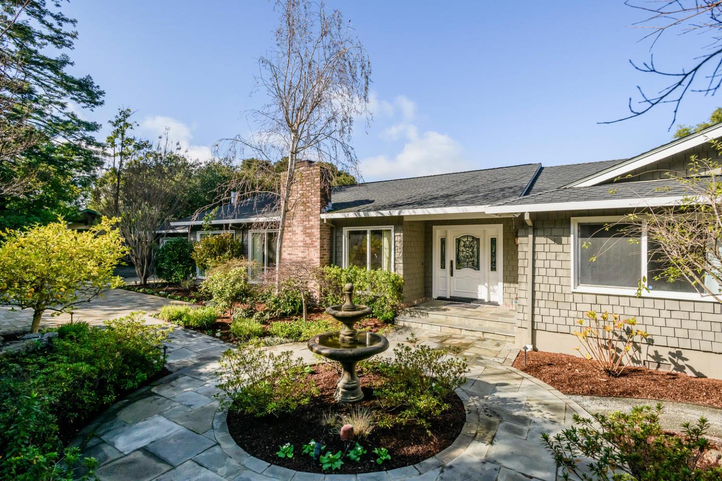 2950 Summit Drive Hillsborough, CA 94010 - Photo 25 of 27 a front view of a house with garden