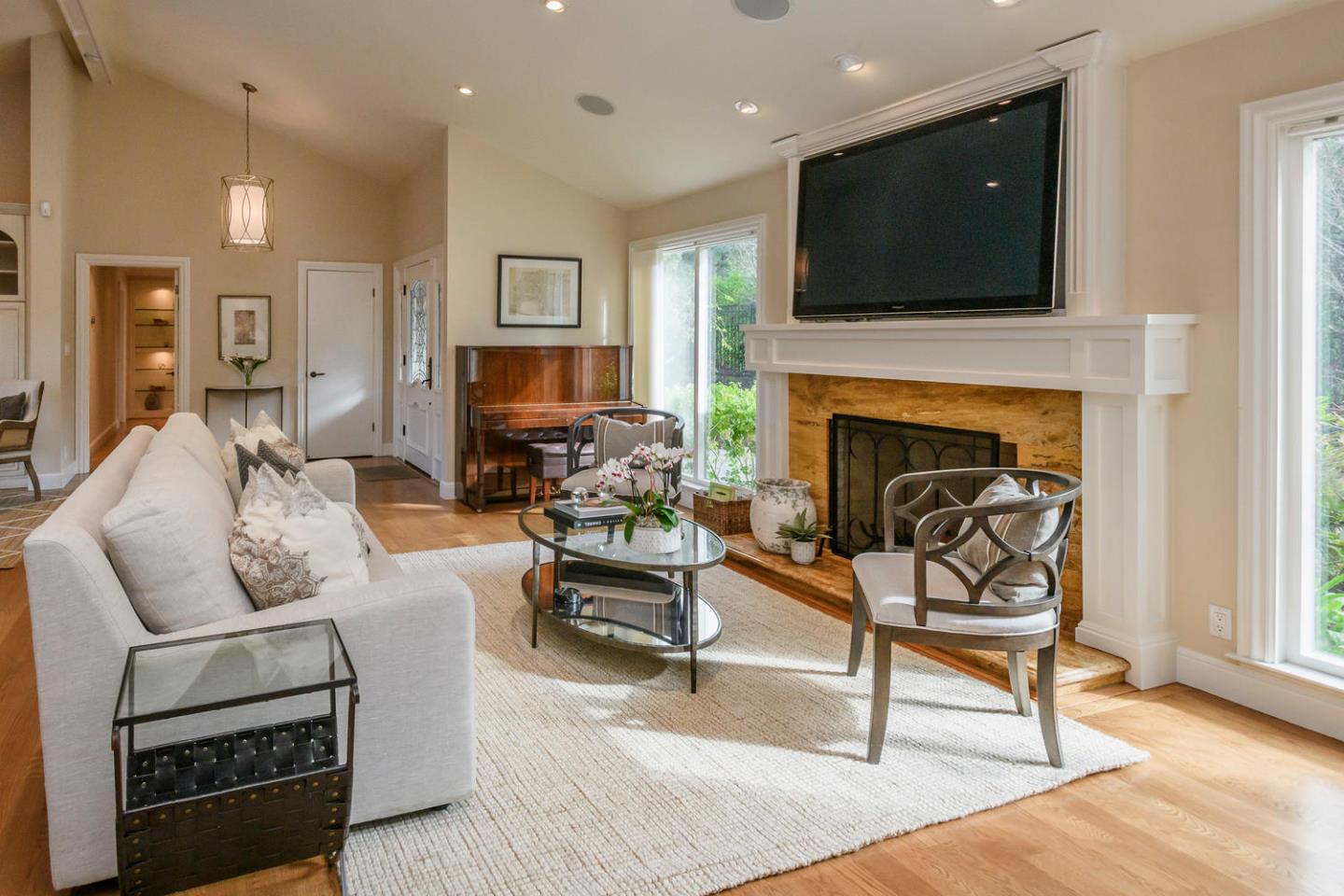 2950 Summit Drive Hillsborough, CA 94010 - Photo 6 of 27 a living room with furniture a fireplace and a flat screen tv