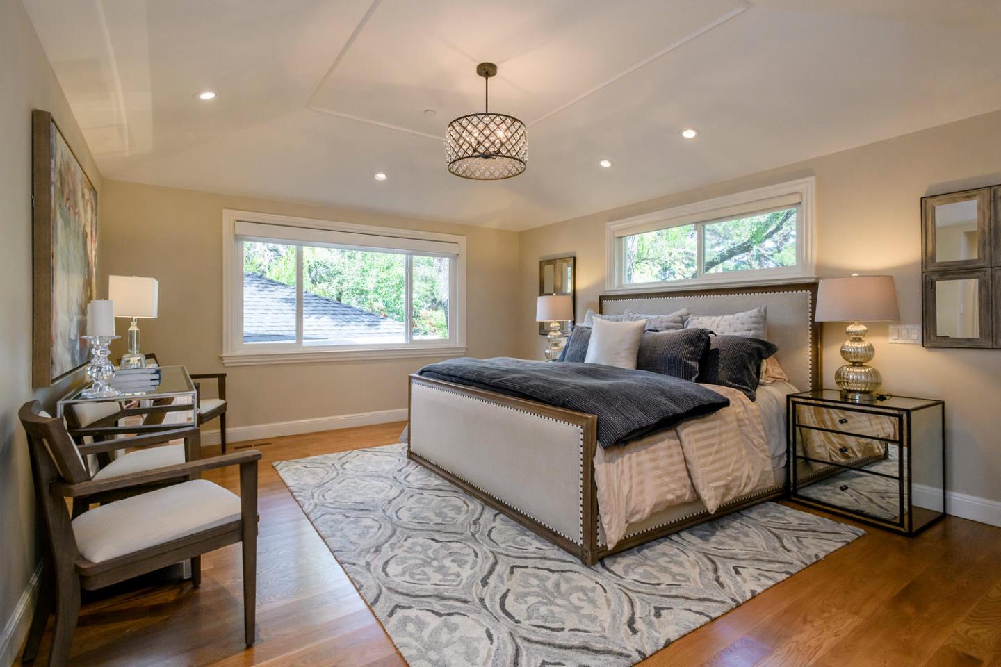 2950 Summit Drive Hillsborough, CA 94010 - Photo 8 of 27 a bedroom with a bed and a chandelier