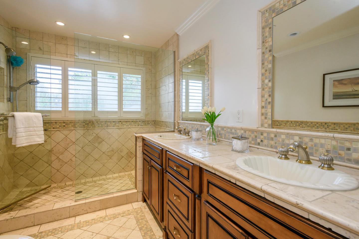 2950 Summit Drive Hillsborough, CA 94010 - Photo 9 of 27 a bathroom with a granite countertop sink a large mirror a bathtub and next to a window