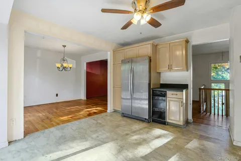 a view of a kitchen with a sink and a refrigerator