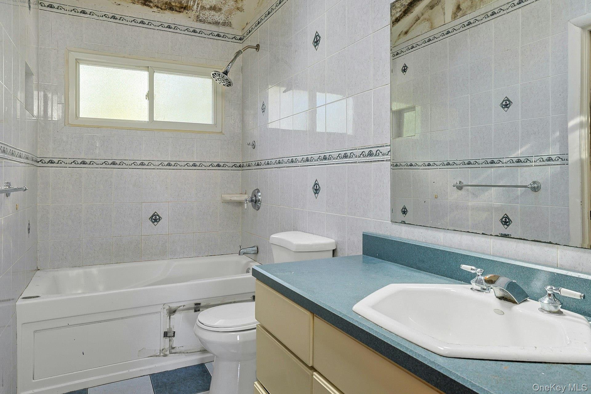 78 Croton Dam Road Ossining, NY 10562 - Photo 20 of 37 a bathroom with a granite countertop toilet sink and mirror