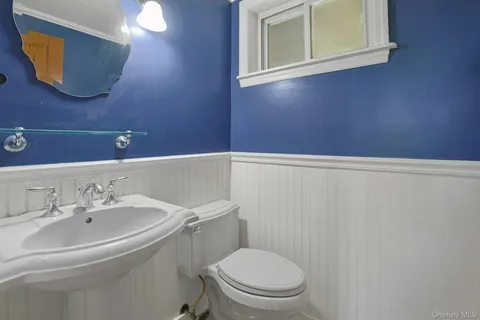 a bathroom with a sink a mirror and a toilet