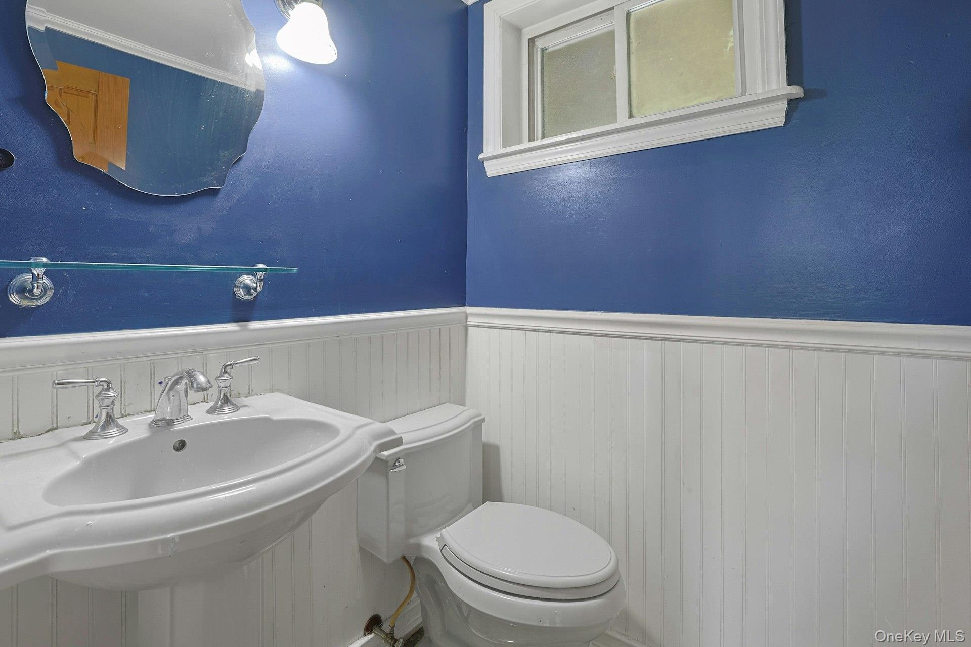 78 Croton Dam Road Ossining, NY 10562 - Photo 25 of 37 a bathroom with a sink a mirror and a toilet
