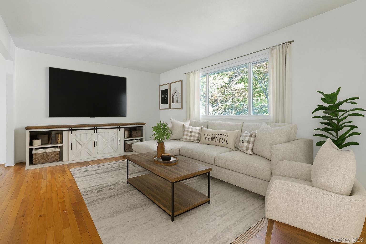 78 Croton Dam Road Ossining, NY 10562 - Photo 5 of 37 a living room with furniture and a flat screen tv