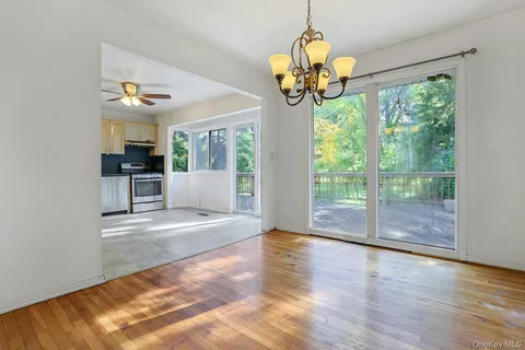 a view of an entryway with wooden floor and chandelier