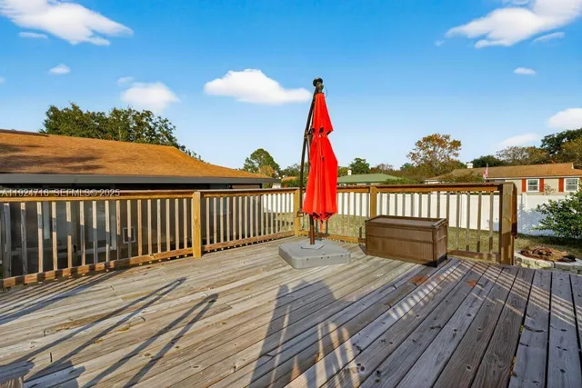 a view of a balcony with chair and wooden floor