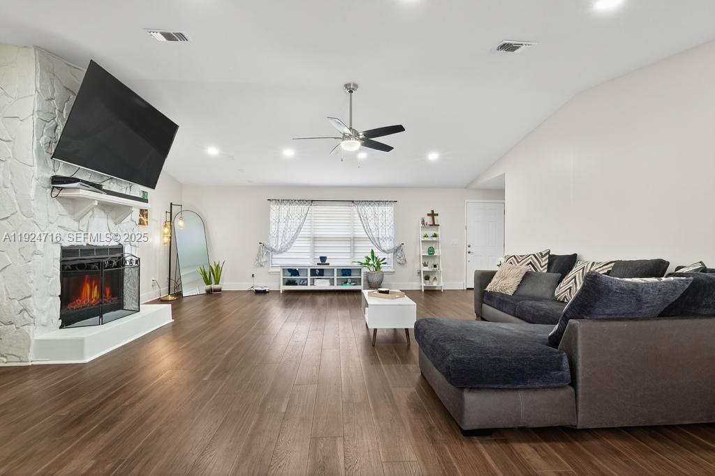 8210 Sailmaker Lane Jacksonville, FL 32210 - Photo 19 of 61 a living room with furniture a fireplace and a flat screen tv