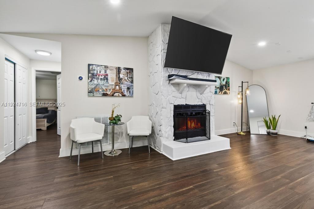 8210 Sailmaker Lane Jacksonville, FL 32210 - Photo 20 of 61 a living room with furniture a fireplace and a flat screen tv