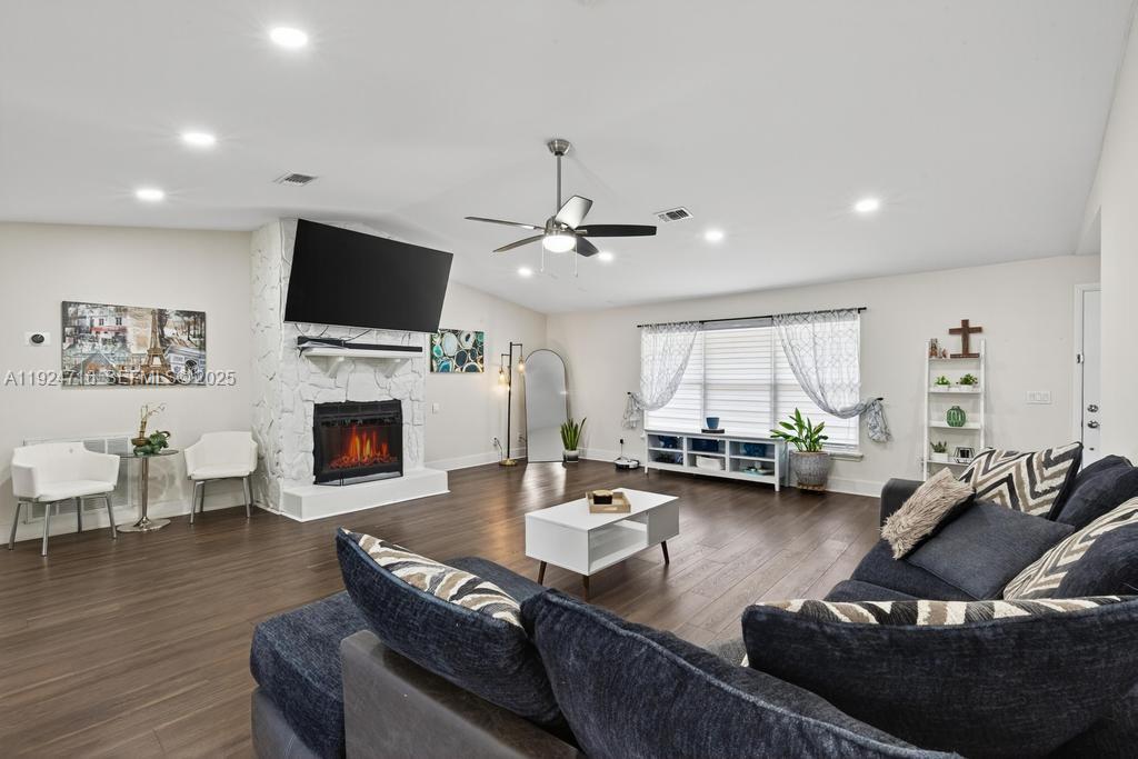 8210 Sailmaker Lane Jacksonville, FL 32210 - Photo 22 of 61 a living room with furniture a fireplace and a flat screen tv