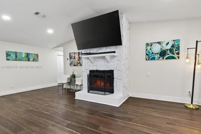 a large white kitchen with stainless steel appliances a large window a oven a sink and a large window