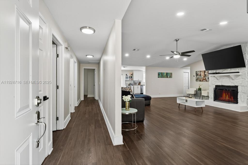 8210 Sailmaker Lane Jacksonville, FL 32210 - Photo 24 of 61 a living room with furniture a flat screen tv and a fireplace