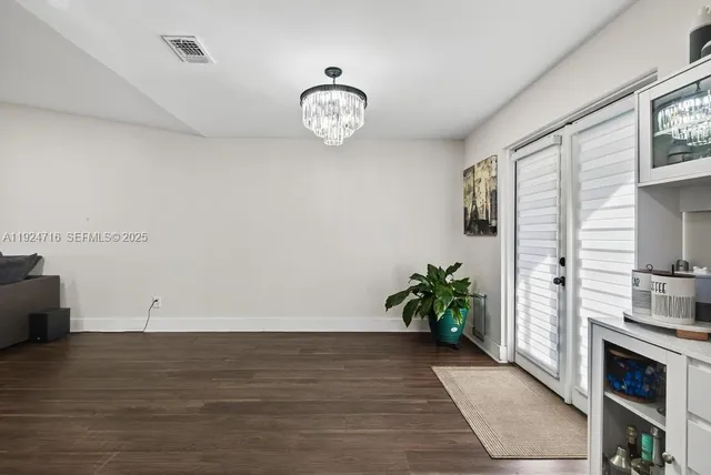 a kitchen with stainless steel appliances granite countertop a sink cabinets and wooden floor