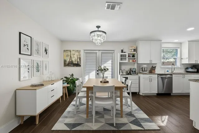 a kitchen with stainless steel appliances granite countertop a stove top oven a sink dishwasher and a refrigerator