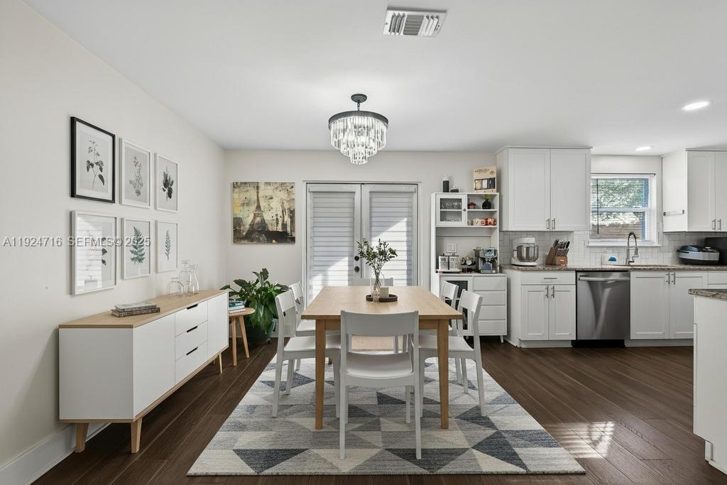 8210 Sailmaker Lane Jacksonville, FL 32210 - Photo 29 of 61 a very nice looking dining room with a dining table wooden floor and a window