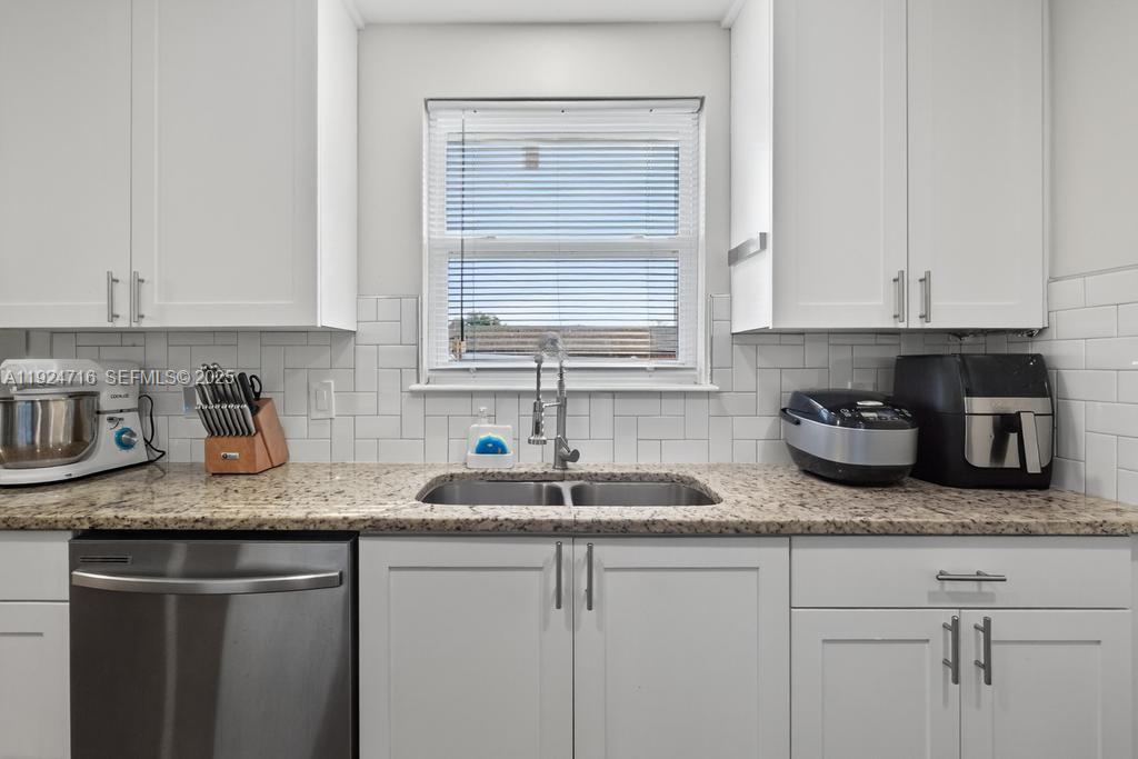 8210 Sailmaker Lane Jacksonville, FL 32210 - Photo 32 of 61 a kitchen with granite countertop white cabinets and a sink