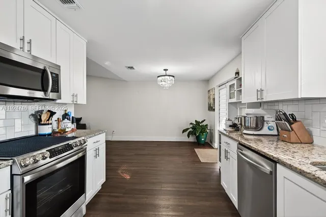 a bathroom with a sink toilet a mirror and shower
