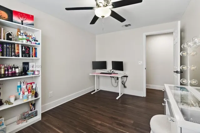 a bedroom with a large bed and a flat tv screen on dresser