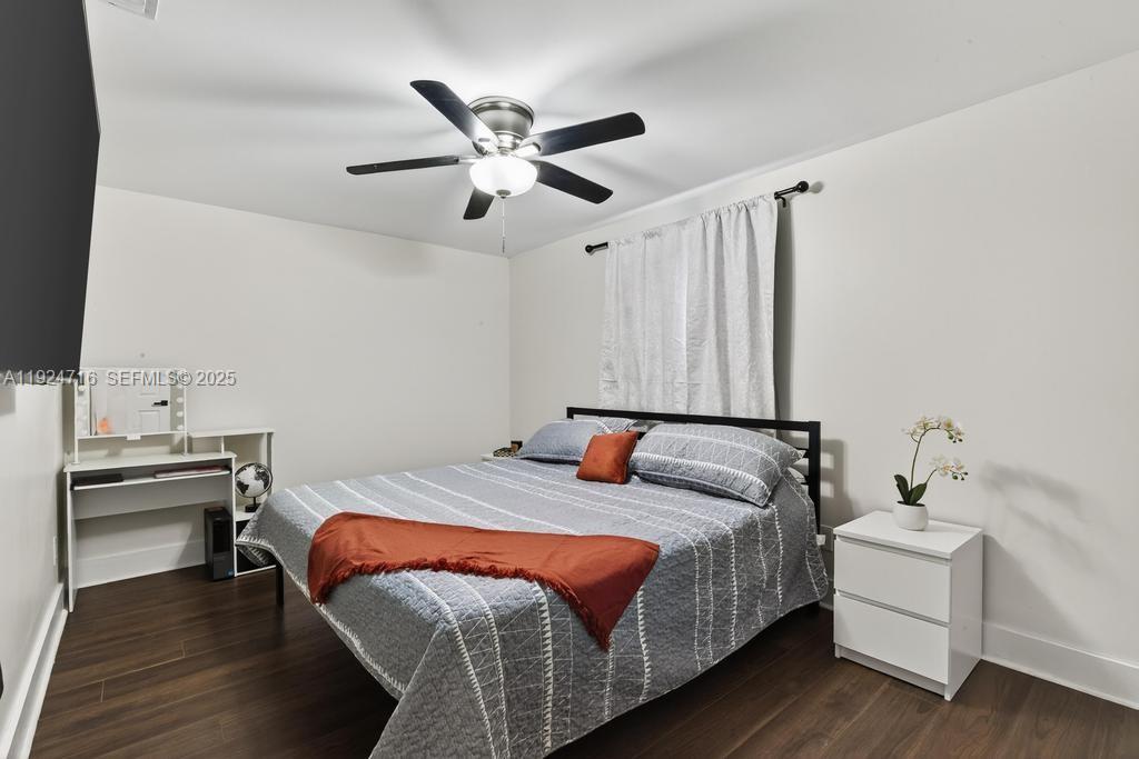 8210 Sailmaker Lane Jacksonville, FL 32210 - Photo 44 of 61 a bedroom with a bed and a chandelier