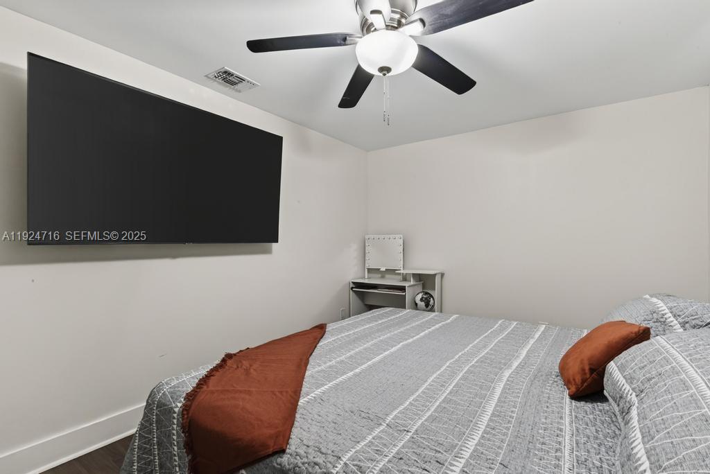 8210 Sailmaker Lane Jacksonville, FL 32210 - Photo 45 of 61 a bedroom with a bed and a flat screen tv