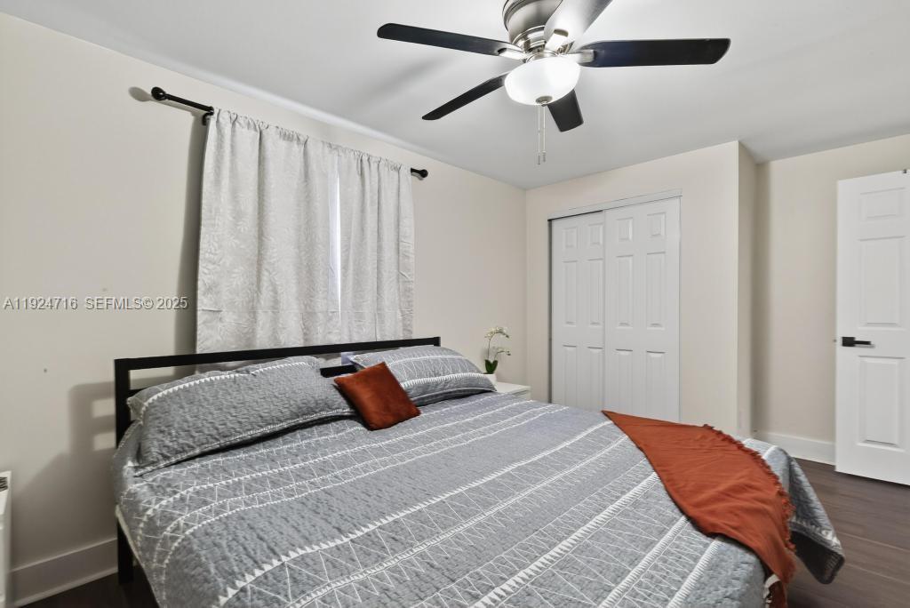 8210 Sailmaker Lane Jacksonville, FL 32210 - Photo 46 of 61 a bedroom with a bed and a chandelier