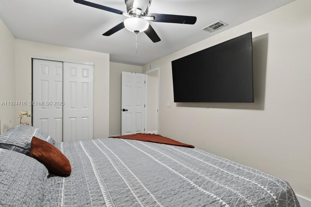 8210 Sailmaker Lane Jacksonville, FL 32210 - Photo 47 of 61 a bedroom with a bed and a flat screen tv
