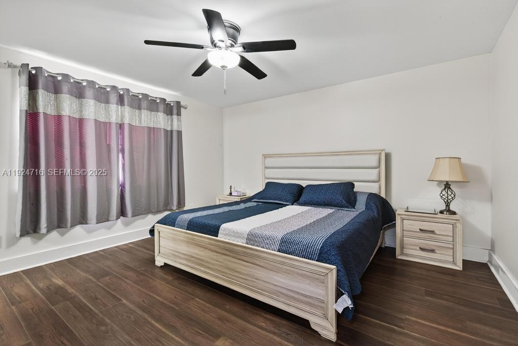 8210 Sailmaker Lane Jacksonville, FL 32210 - Photo 48 of 61 a bedroom with a bed and a chandelier