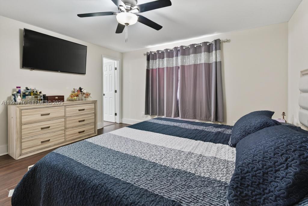 8210 Sailmaker Lane Jacksonville, FL 32210 - Photo 49 of 61 a bedroom with a large bed and a flat tv screen on dresser