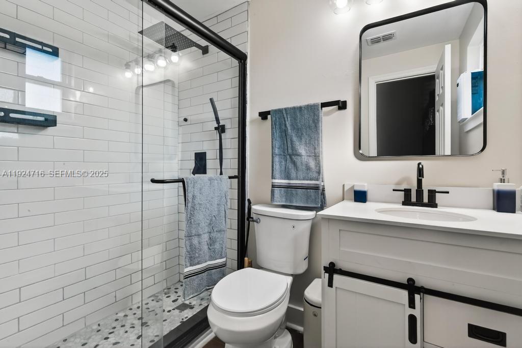 8210 Sailmaker Lane Jacksonville, FL 32210 - Photo 50 of 61 a bathroom with a sink toilet vanity and shower