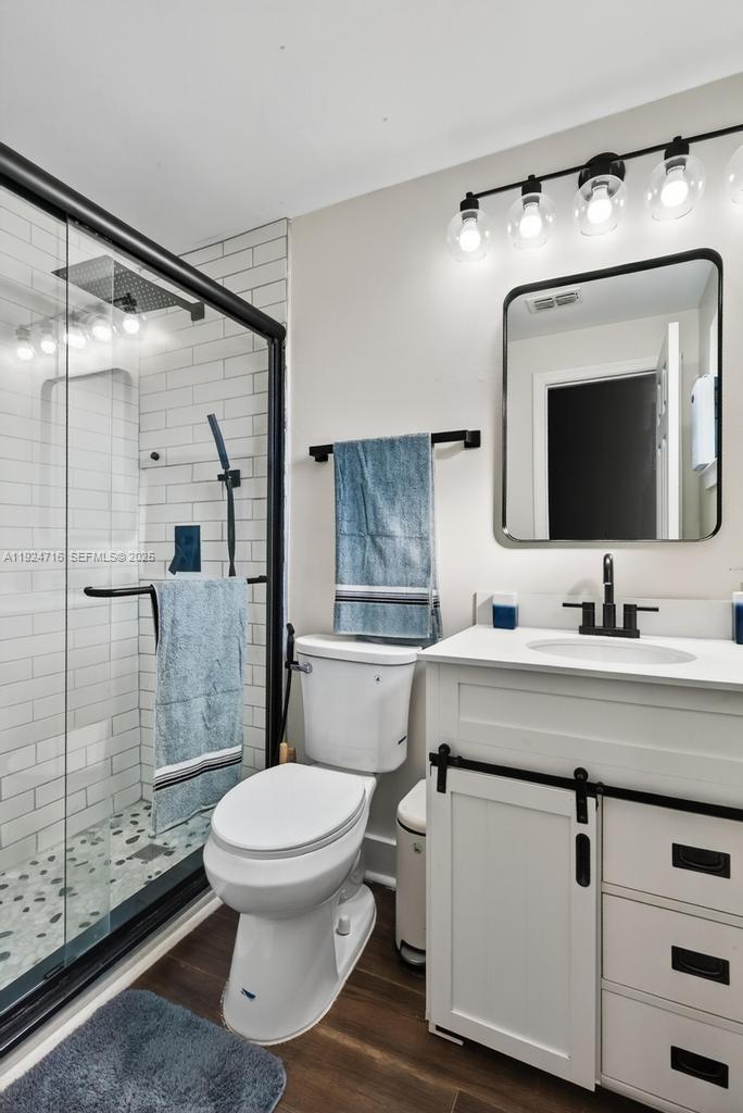 8210 Sailmaker Lane Jacksonville, FL 32210 - Photo 51 of 61 a bathroom with a toilet sink and mirror