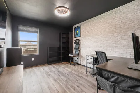 a workspace with furniture window and wooden floor