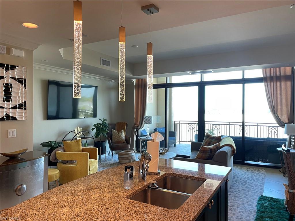 9115 Strada Place, Unit 5417 Naples, FL 34108 - Photo 1 of 21 a kitchen with granite countertop a sink and a counter top space