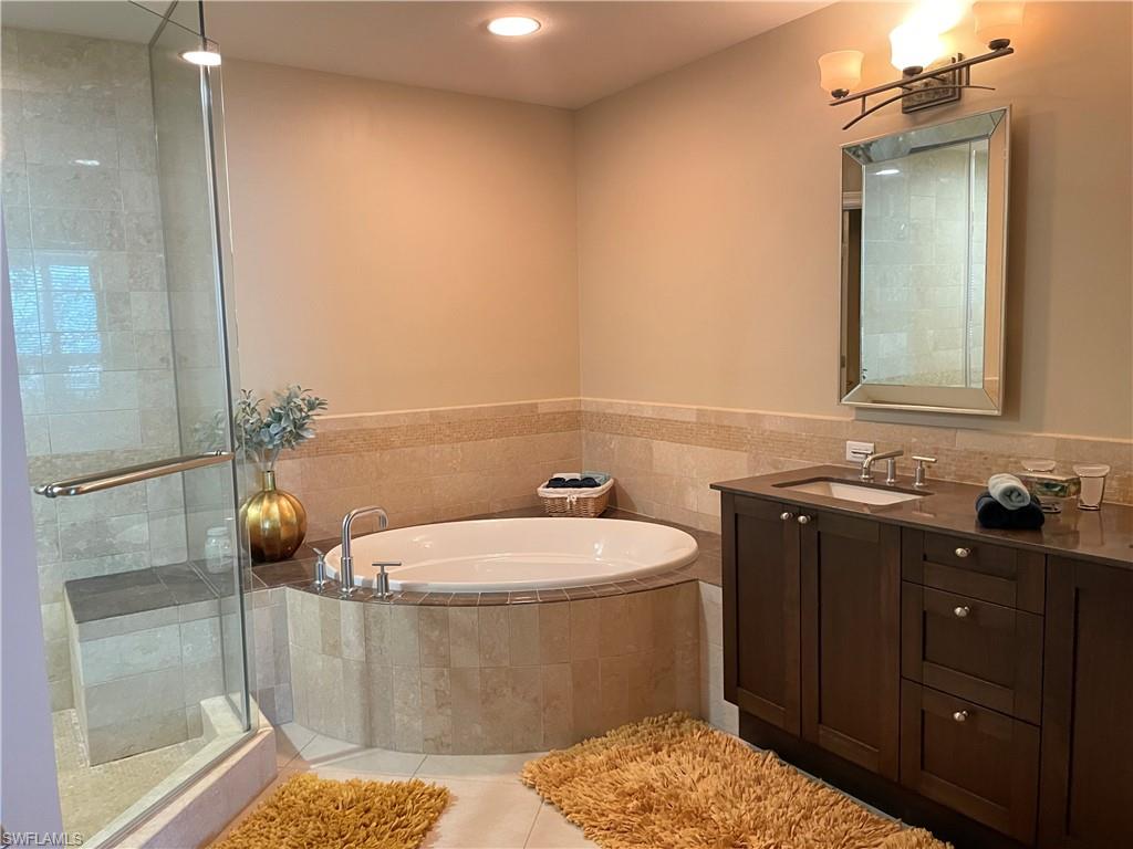 9115 Strada Place, Unit 5417 Naples, FL 34108 - Photo 12 of 21 a bathroom with a sink a toilet and shower