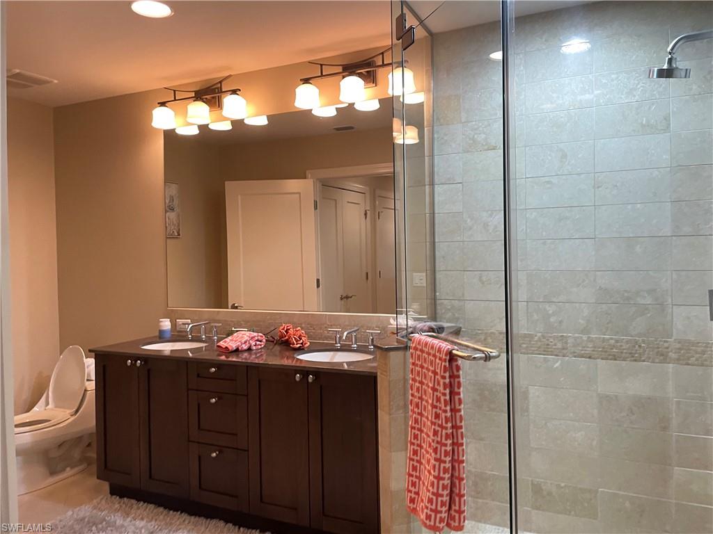9115 Strada Place, Unit 5417 Naples, FL 34108 - Photo 18 of 21 a bathroom with a sink and a mirror
