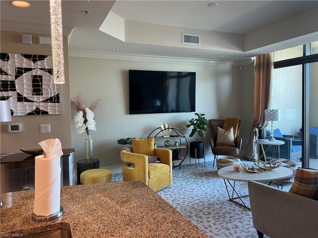 9115 Strada Place, Unit 5417 Naples, FL 34108 - Photo 4 of 21 a living room with furniture and a flat screen tv