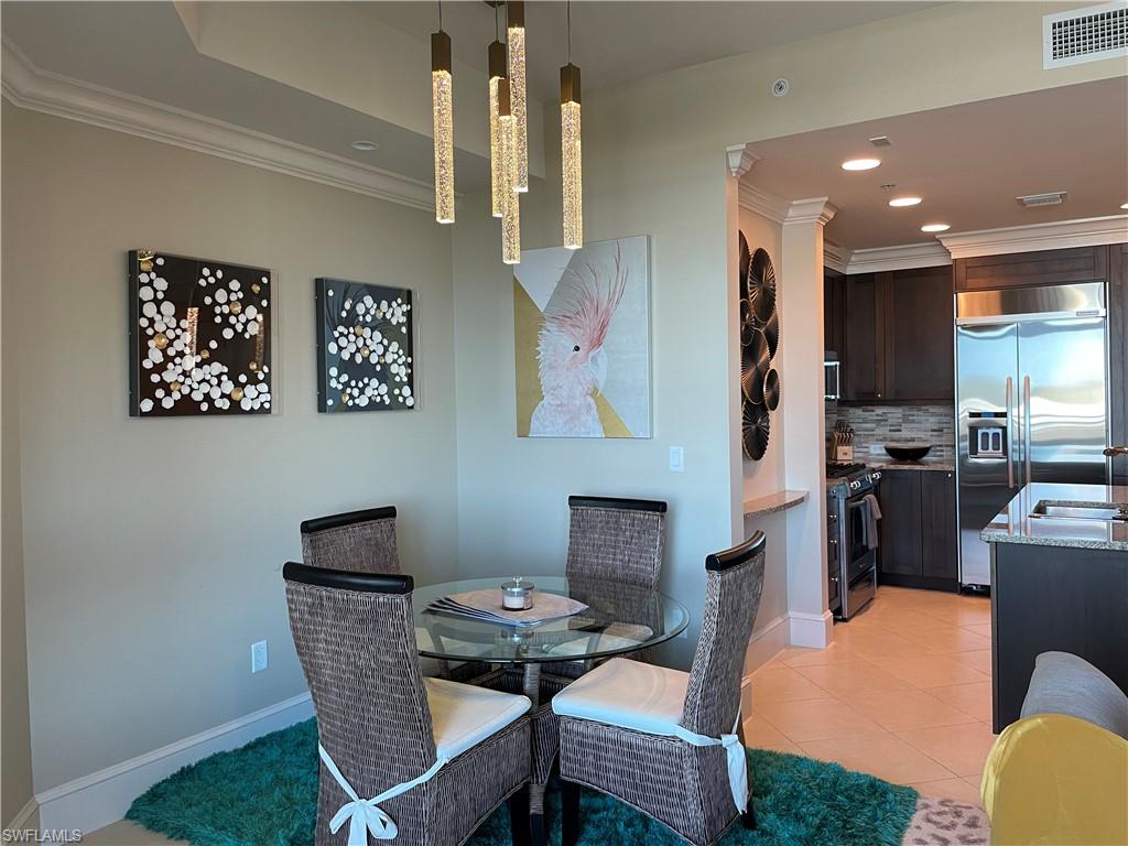 9115 Strada Place, Unit 5417 Naples, FL 34108 - Photo 6 of 21 a view of a dining room with furniture