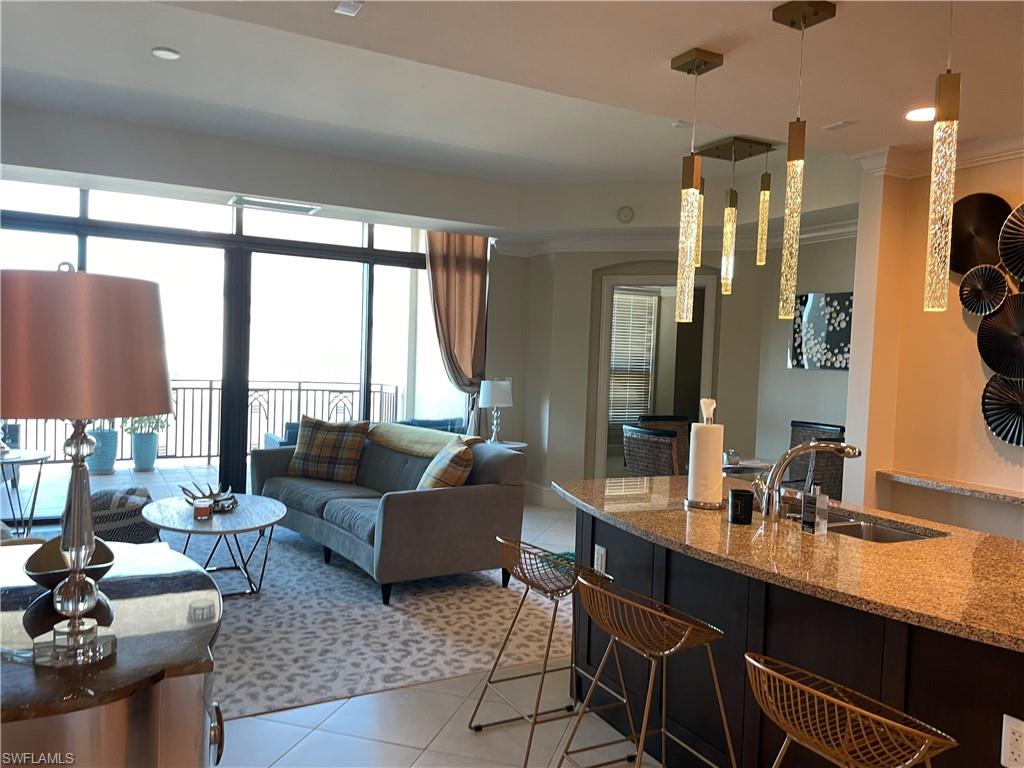 9115 Strada Place, Unit 5417 Naples, FL 34108 - Photo 7 of 21 a living room with furniture and large windows