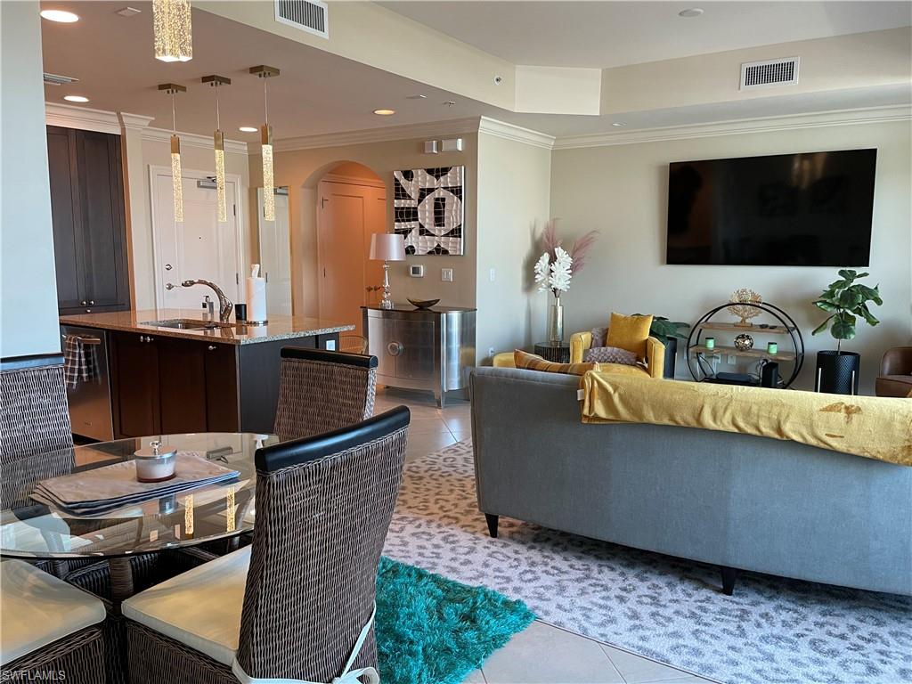 9115 Strada Place, Unit 5417 Naples, FL 34108 - Photo 9 of 21 a living room with furniture and a flat screen tv