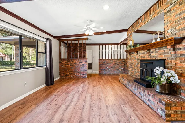 a view of a room with wooden floor and windows